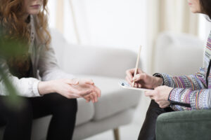 Therapist with teen girl to treat for eating disorder mental health challenges